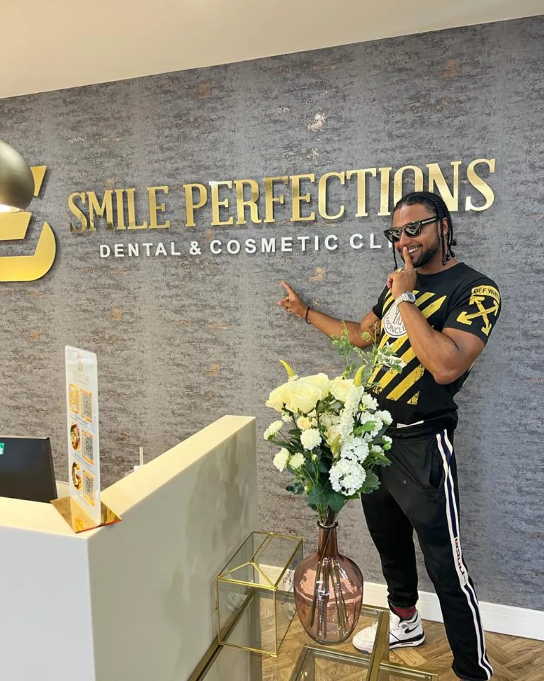 The Smile Perfections reception desk with a patient